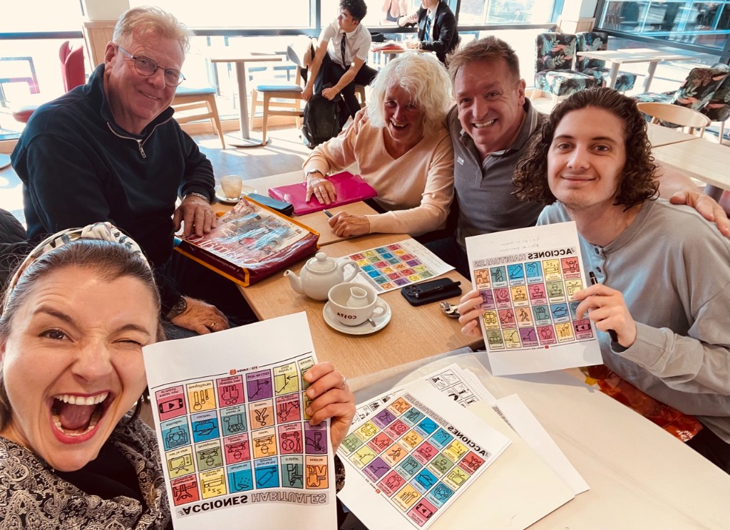 Students smiling during a Spanish group session