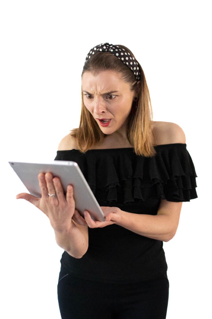 Julia looking puzzled at a tablet